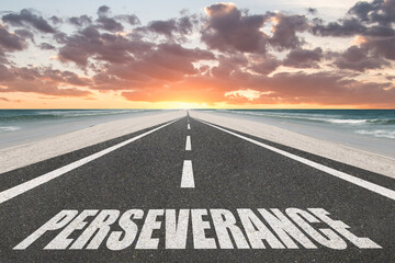 Motivational Perseverance text on highway with sunset at the beach.