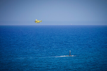 Firefighting plane flying above the sea