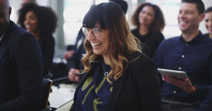 4k video footage of a young businesswoman laughing during a conference meeting