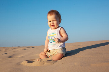 baby boy playing with sand on the beach.Summer, summer vacation at sea,vacation. Baby up to one year old.