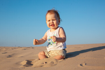 baby boy playing with sand on the beach.Summer, summer vacation at sea,vacation. Baby up to one year old.