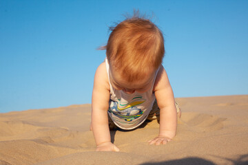 baby boy playing with sand on the beach.Summer, summer vacation at sea,vacation. Baby up to one year old.