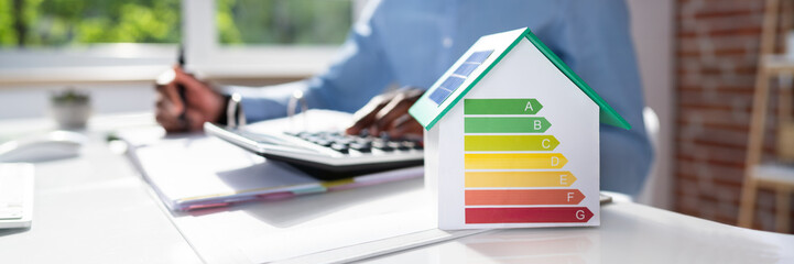 Businessman Calculating House Energy Cost