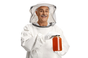 Bee keeper in a uniform holding a honey jar