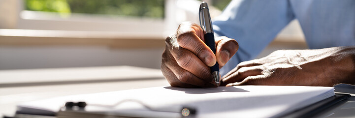 Man Hands Writing On Clipboard With Pen