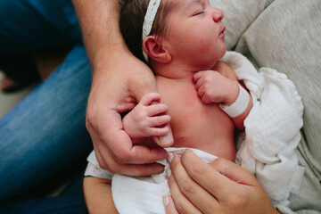 closeup view of newborn baby grasping dad's thumb