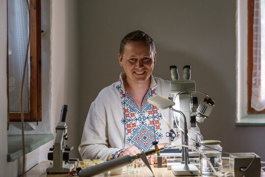 Happy male beekeeper in lab