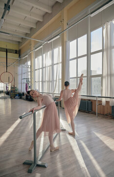 two ballerinas in the hall on a stretch
