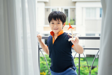 Happy boy playing solar panel windmill 