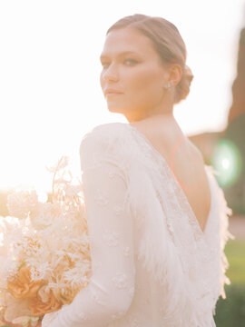 Blond Bride With Bouquet Of Flowers Outdoors
