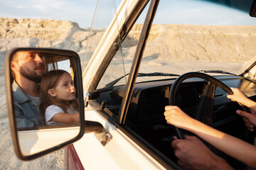 Dad and daughter steering car