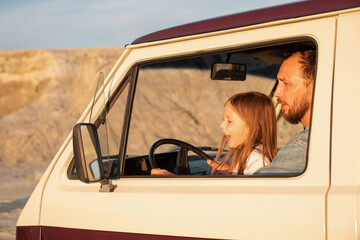 Excited daughter driving van with father