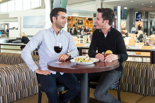 Two Men Enjoy a Pre-Flight Beverage at an Airport