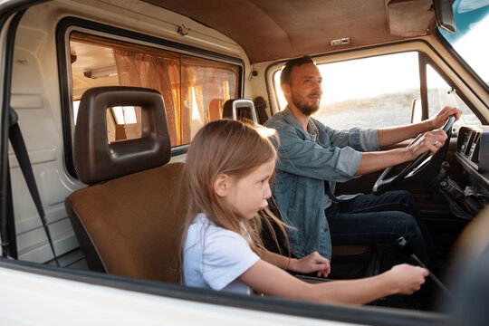 Daughter riding van with father
