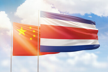 Sunny blue sky and flags of costa rica and china