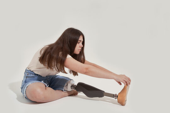 Female amputee bending forward and stretching