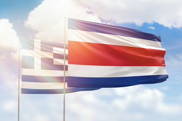 Sunny blue sky and flags of costa rica and greece