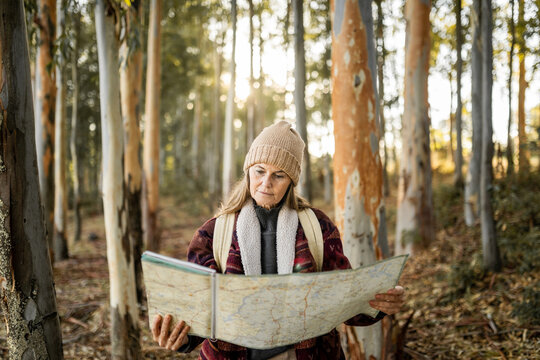 mature woman with map in nature