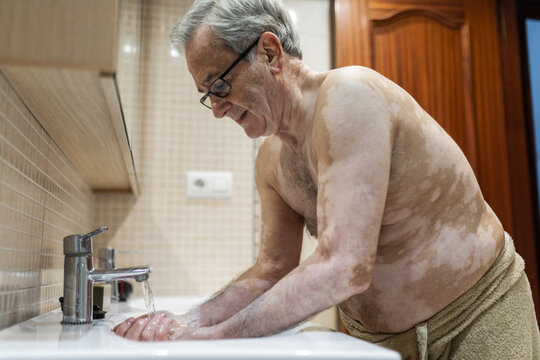 old man washing in the bathroom