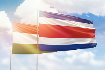Sunny blue sky and flags of costa rica and hungary