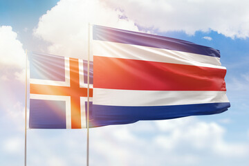 Sunny blue sky and flags of costa rica and iceland