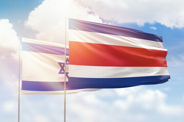 Sunny blue sky and flags of costa rica and israel