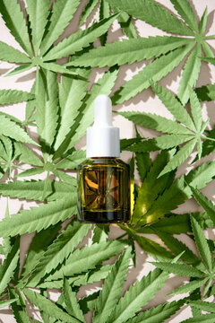 Cannabis oil extracts with hemp leaves background