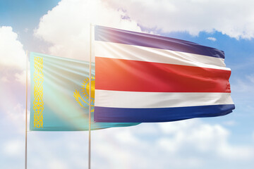 Sunny blue sky and flags of costa rica and kazakhstan