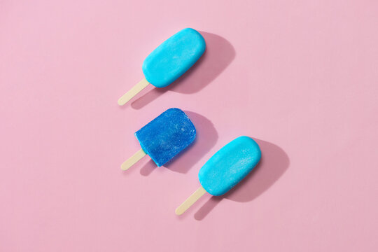 Ice cream stick put on pink background with copy space.