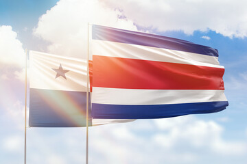 Sunny blue sky and flags of costa rica and panama