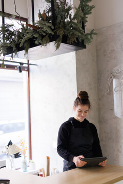 Female florist  accepting online requests from clients 