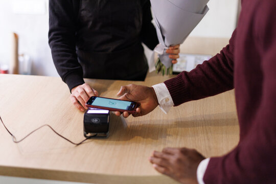 Visitor paying for order by smartphone 