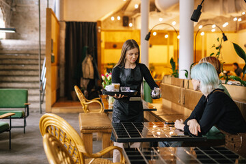 Barista delivering requested beverages to visitors 