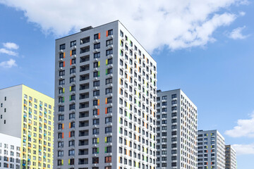 New modern residential apartment buildings newly build on blue cloudy sky