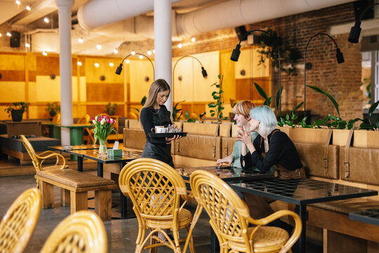Visitors feeling happy about service in modern restaurant 