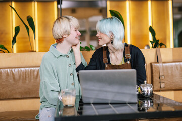 Woman paying attention to girlfriend during working process