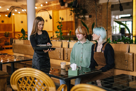 Female clients enjoying professional service in cafe 