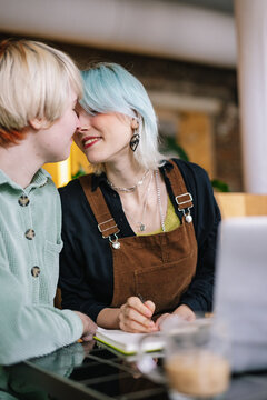 Girl diverting on kiss, while completing online tasks 
