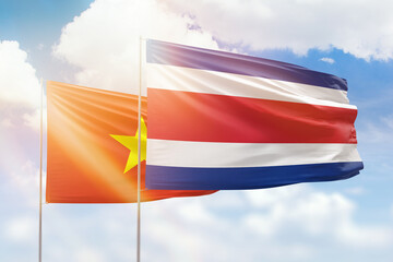Sunny blue sky and flags of costa rica and vietnam
