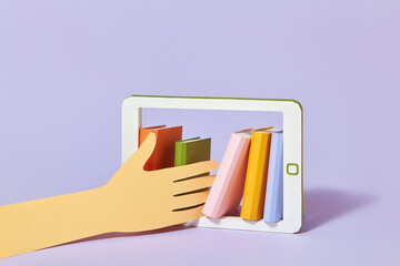 Hand takes books from tablet