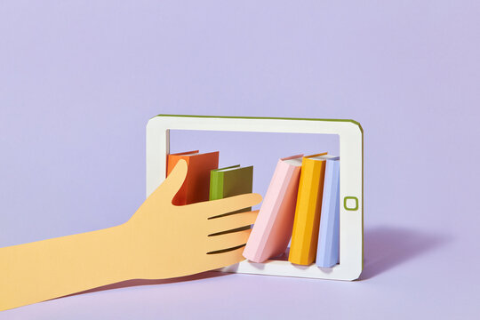 Hand takes books from tablet - Powered by Adobe