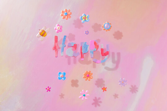 Flower and Happy word from made of colored modeling clay