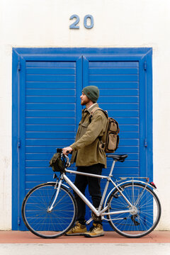 Backpacker man walking with bicycle