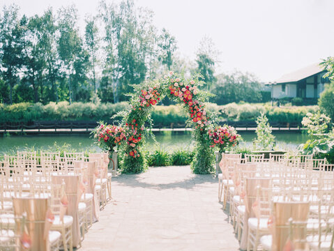 Wedding Arch Of Leaves And Red Flowers