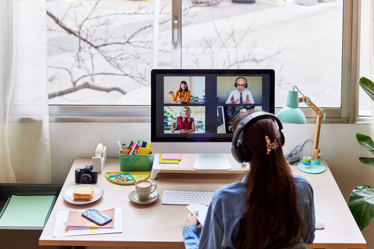 Anonymous brunette having online meeting with coworkers