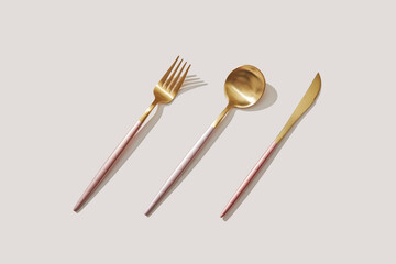 Set of elegant golden fork, spoon and knife