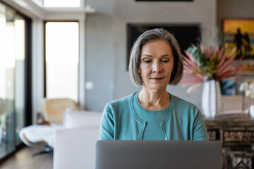 Older Woman Types On Her Laptop