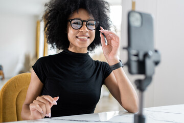 Uses a telephone video chat a smiling freelance woman working in an office