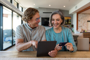 Couple Laughs While Shopping Online