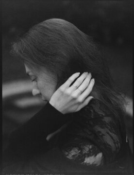 A sad woman touching her head